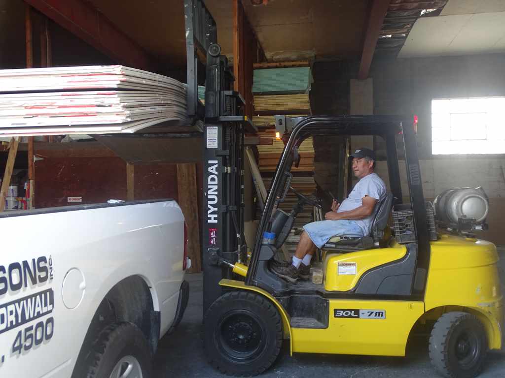 roberto on forklift with sheet rock