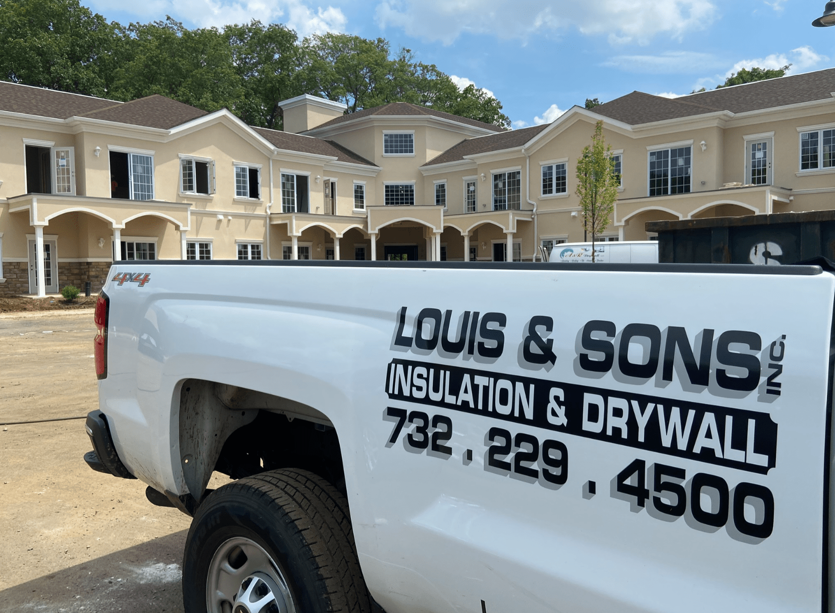 Louis and Sons truck in front of living complex