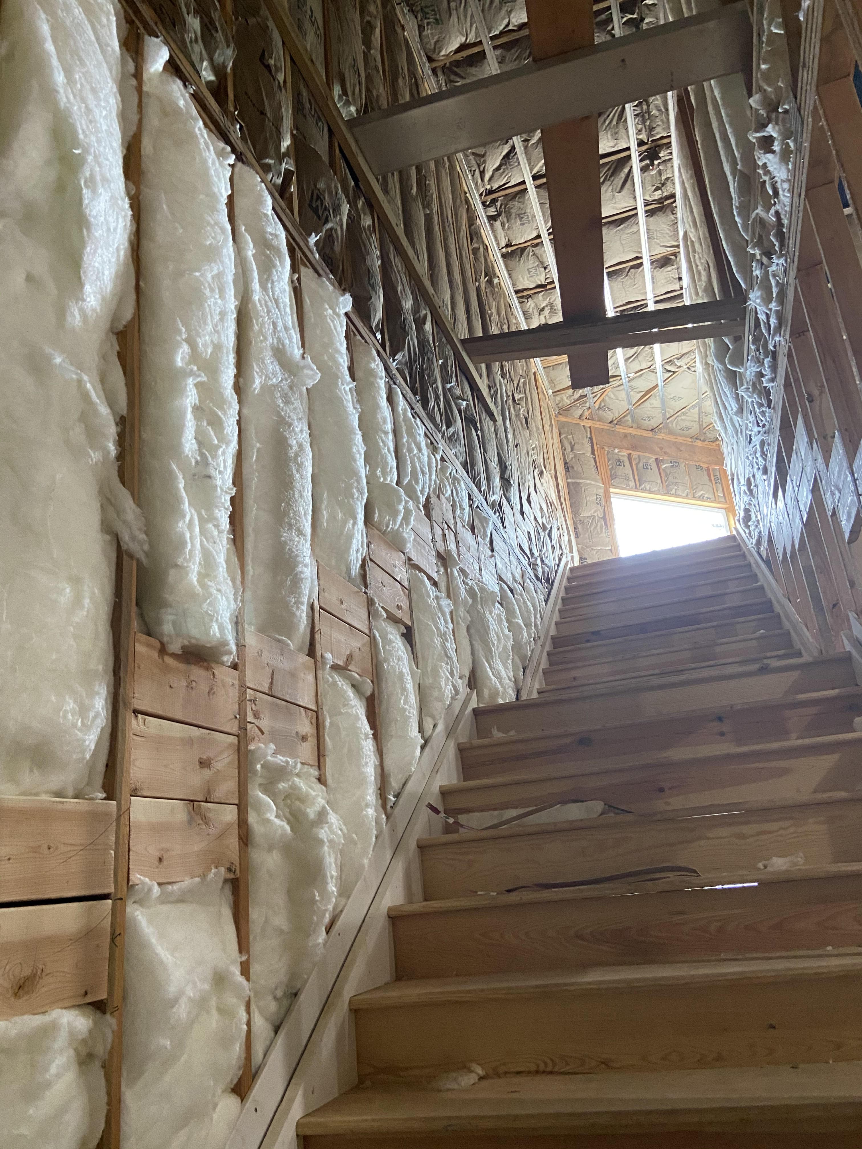 view looking up the stairs at insulated walls on sides