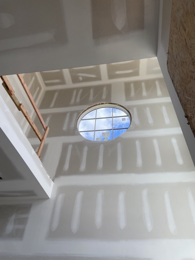 Circular window custom trimmed drywall in Asbury Park, New Jersey.