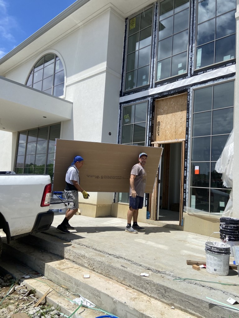 Percy carrying drywall