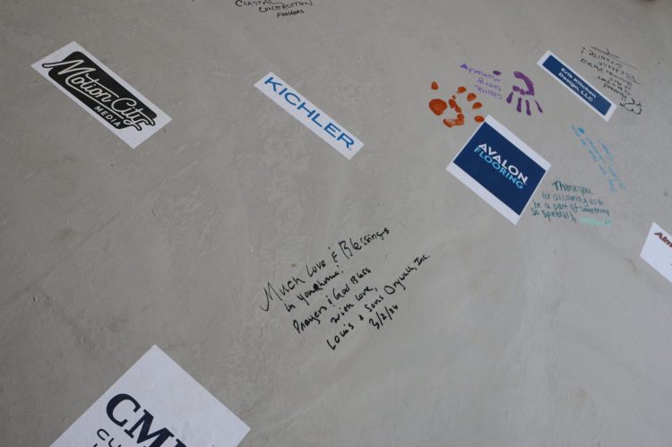 Message signed from Louis & Sons Drywall, Inc. on St. Jude Dream Home floor that reads, "Much love and blessings in your home. Prayers and God bless with love, Louis & Sons Drywall, Inc. 3/2/26." 