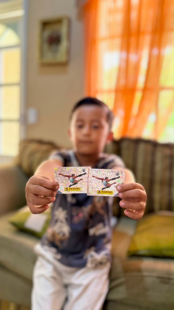jose jr's son holding up stickers to camera