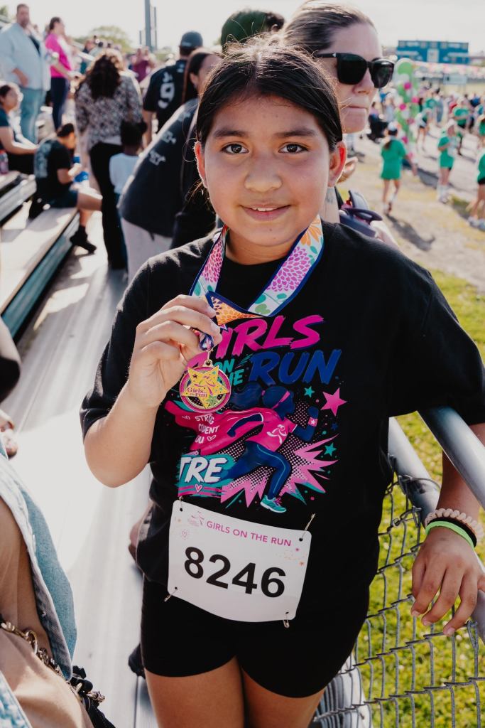 Norman's daughter with Girls on the Run medal