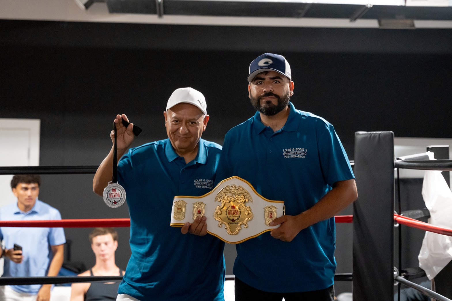 percy and guillermo holding medal and belts