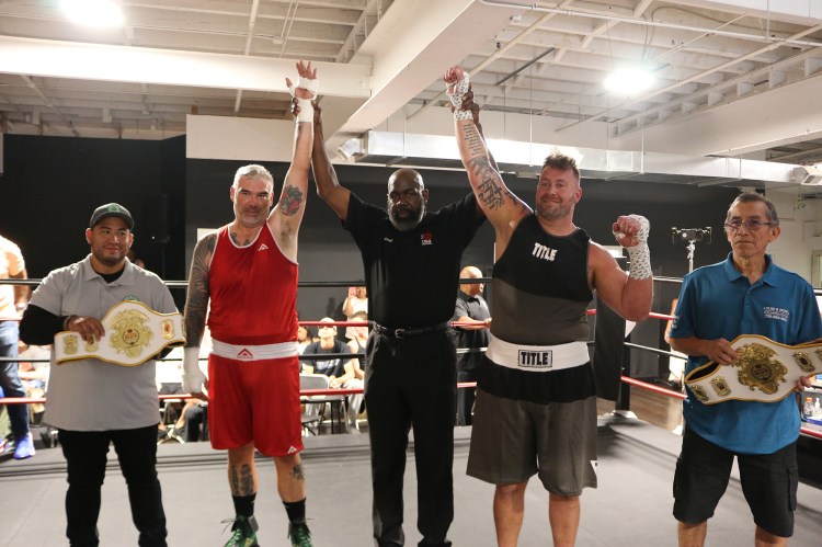 Norman and Percy holding winning belts